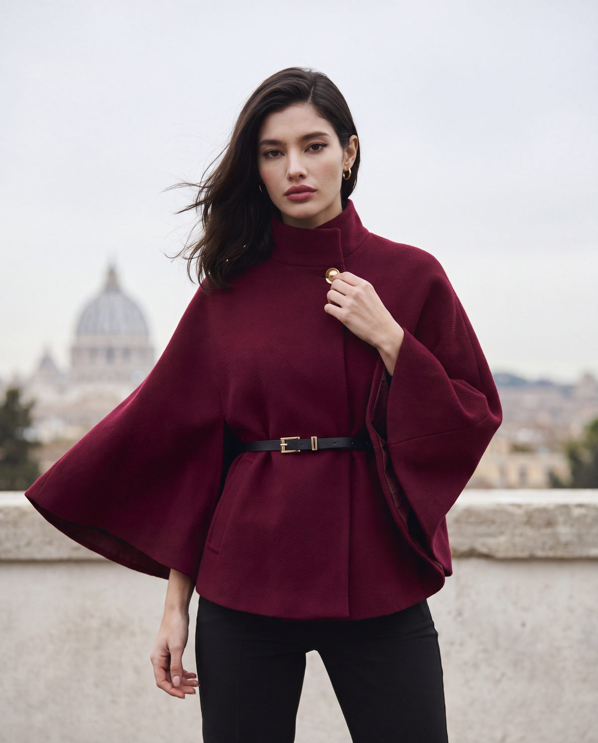 ELARA belted cape in wine red on a Rome terrace in winter