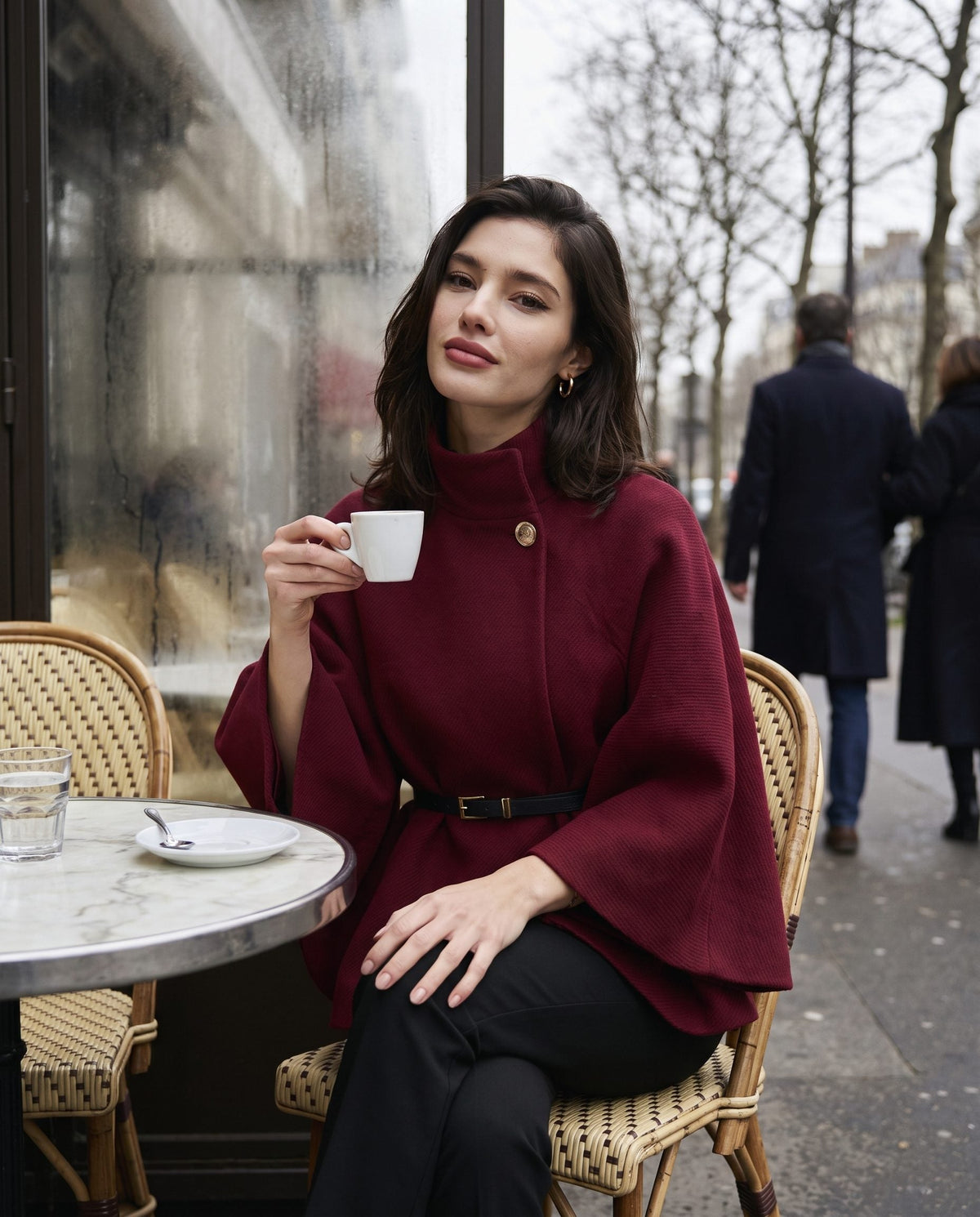 ELARA belted cape in wine red at a Paris cafe terrace