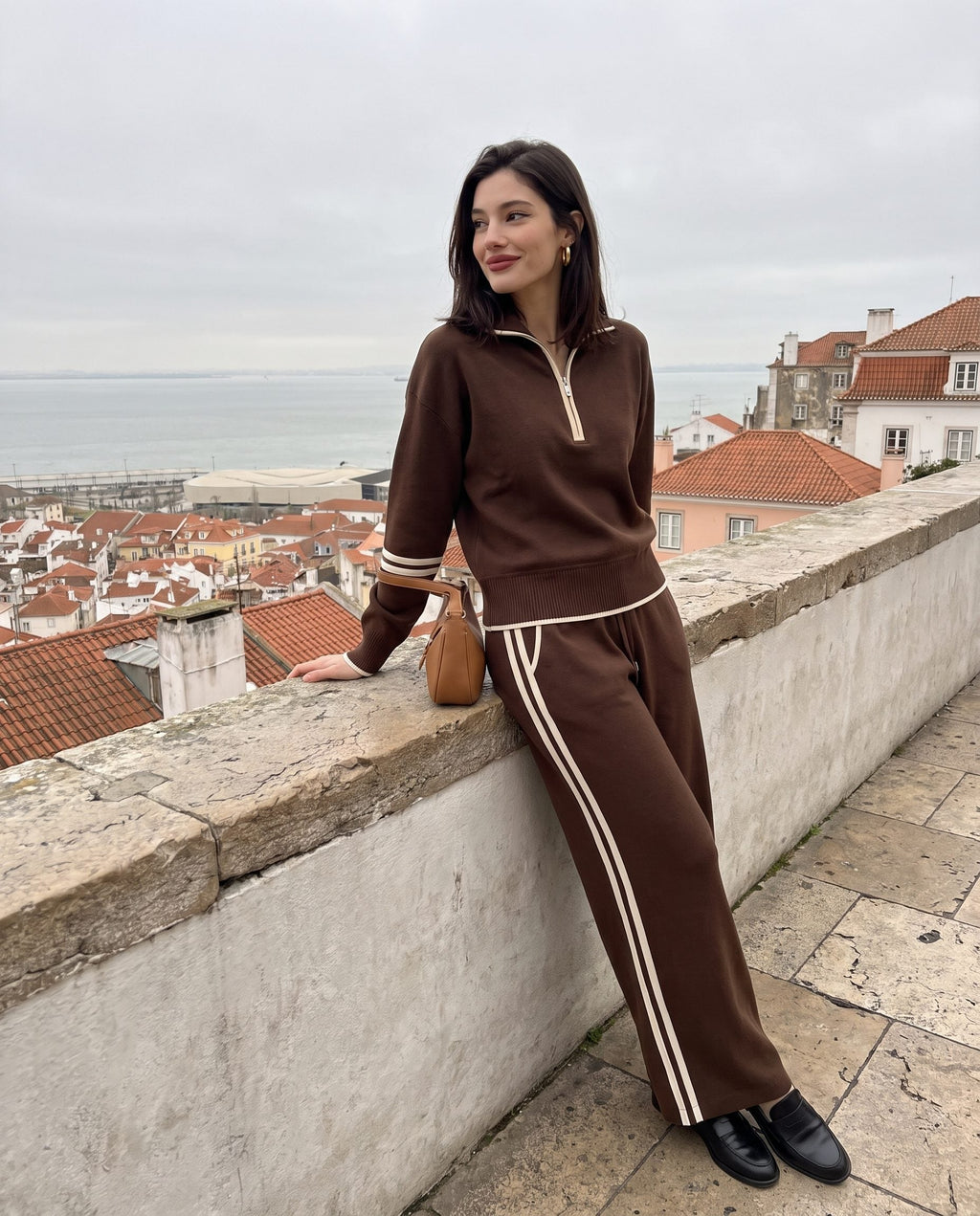 Half-zip knit lounge set in brown at a viewpoint over Lisbon
