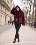 Aveline faux fur jacket in wine red, worn on a Paris street in winter
